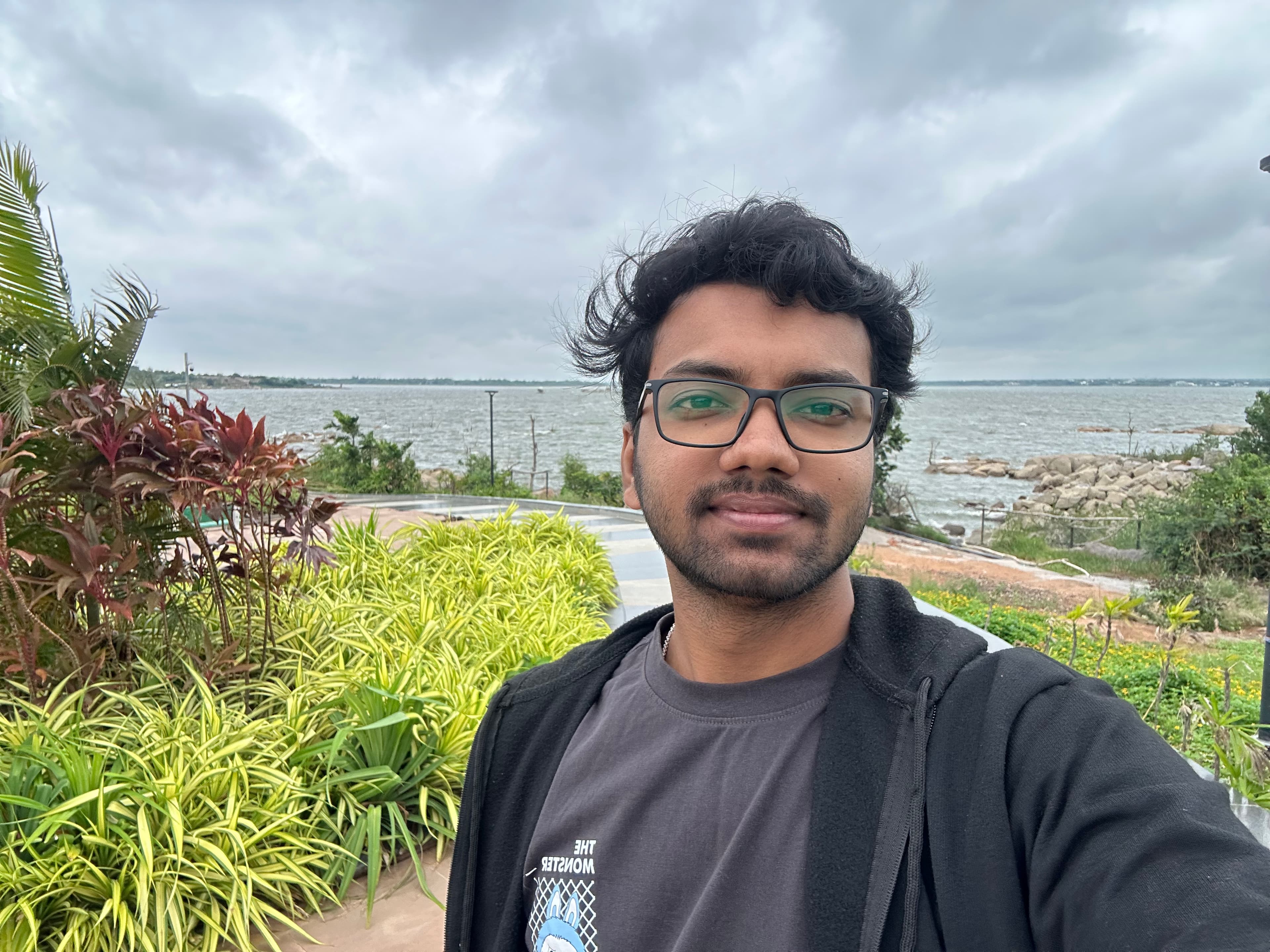 Sainath Reddy, by the water on an overcast day